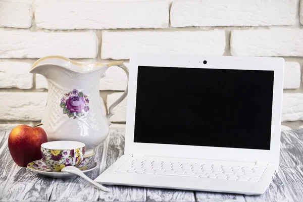 Beyaz dizüstü bilgisayar ve bir bardak süt 