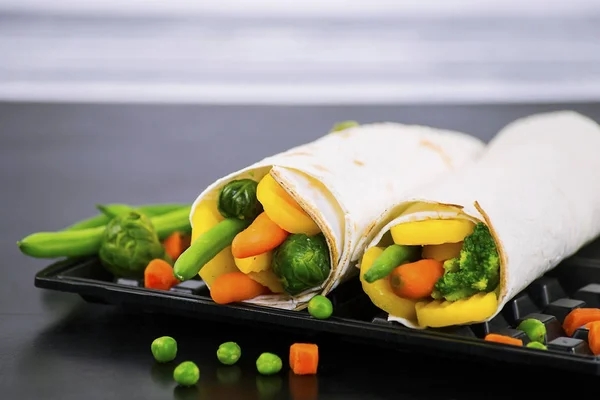 Pita bread stuffed with vegetables and asparagus, healthy breakfast on the table