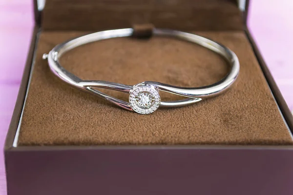 silver bracelet with a diamond in a box