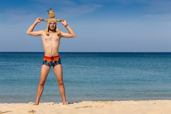 Portrait of an attractive young man on a tropical beach — Stock Photo, Image