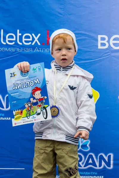 Kazakistan, Almaty - 11 Haziran 2017: yarışmalar Bisiklete binme çocuk de çocuklar tur. 2 ile 7 yaş arası çocuklar stadyumda rekabet ve ödüller alırsınız. Heyecanlı çocuk ve madalya kızlarla
