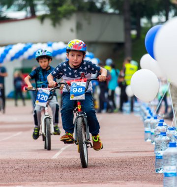 Kazakistan, Almaty - 11 Haziran 2017: yarışmalar Bisiklete binme çocuk de çocuklar tur. 2 ile 7 yaş arası çocuklar stadyumda rekabet ve ödüller alırsınız. Portre üç küçük bisiklet sürme onların