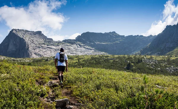 ERGAKI, RUSSIE - 05 AOÛT 2017 : Un athlète masculin inconnu traverse les montagnes, participant à la compétition TRAILANNING SKAYRANFEST le 5 août 2017 dans le parc national d'Ergaki, en Russie . — Photo