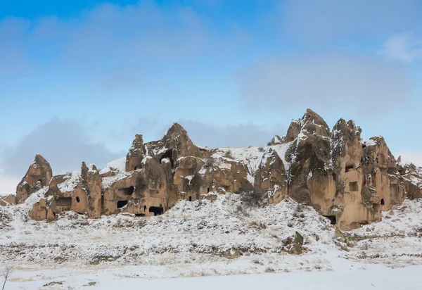 View of ancient Uchisar cave town and a castle of Uchisar dug from a mountains in Cappadocia, Central Anatolia,Turkey. Winter time with sun — Stock Photo, Image