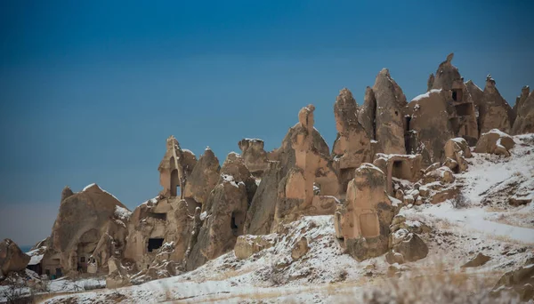 View of ancient Uchisar cave town and a castle of Uchisar dug from a mountains in Cappadocia, Central Anatolia,Turkey. Winter time with sun — Stock Photo, Image