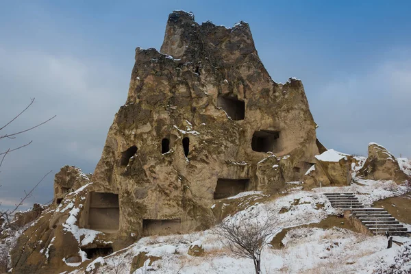 View of ancient Uchisar cave town and a castle of Uchisar dug from a mountains in Cappadocia, Central Anatolia,Turkey. Winter time with sun — Stock Photo, Image