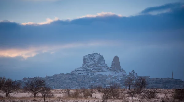 View of ancient Uchisar cave town and a castle of Uchisar dug from a mountains in Cappadocia, Central Anatolia,Turkey. Winter time with sun — Stock Photo, Image