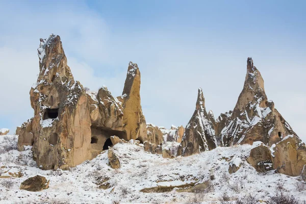 View of ancient Uchisar cave town and a castle of Uchisar dug from a mountains in Cappadocia, Central Anatolia,Turkey. Winter time with sun — Stock Photo, Image