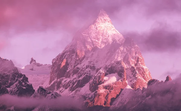 Majestic Himalayan peak among the clouds at sunrise; difficult path to the top, way to achieving goals and dreams through difficulties, barriers and illusions. Machermo peak (6237 m), Nepal, Himalayas