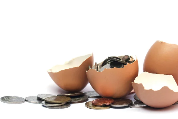 stock image Half egg shell and coin, isolated on white background.In the concept of making money easily from eggs