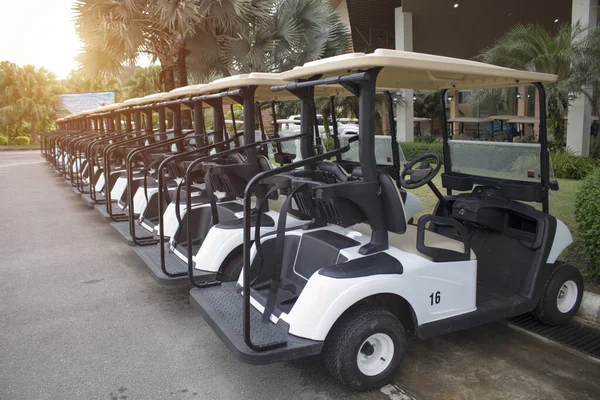 Electric golf cars parked in an orderly manner at the parking lot. Ready for service to golfers who practice or play golf competitions.