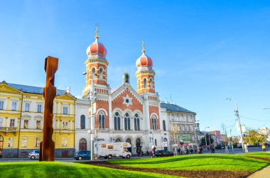 Pilsen, Czech Republic - Oct 28, 2019: The Great Synagogue in Plzen, the second largest synagogue in Europe. Front side facade of the Jewish religious building with onion domes. Road in foreground clipart