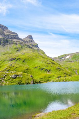 Amazing Bachalpsee lake in the Swiss Alps photographed in the summer season. Alpine lake and landscape. Popular landmark on the hiking path from Grindelwald. Tourist places in Switzerland clipart
