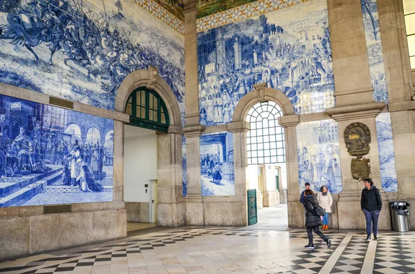 Porto, Portekiz - 10 Ocak 2020 Sao Bento tren istasyonunun içi tipik azulejo fayanslarıyla dolu. Tipik Portekiz fayans işi Azulejos, istasyon Unesco World Heritage Site 'dir. Salondaki insanlar