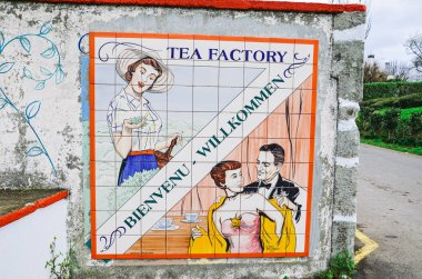 Maia, Azores, Portugal - Jan 14, 2020: Gorreana Tea Plantation in Sao Miguel Island. Entrance to the tea factory with old tile advertisement and sign welcome in French and German. Tea cultivation.
