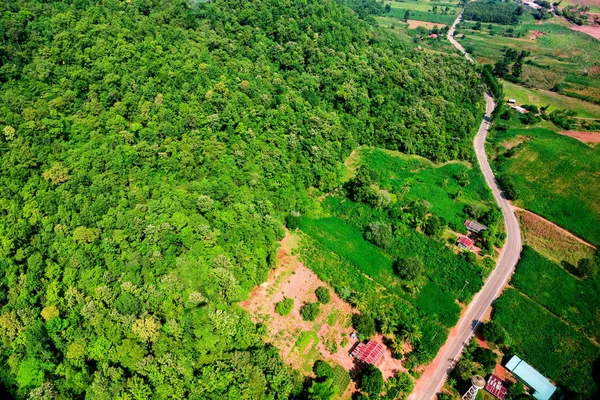 Aerial view over mountain road going through forest landscape — Stock Photo, Image