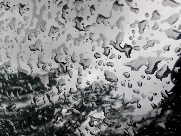 Water Drop on the Hood of the Car. Rain Drops on the Surface of the Car or on the Iron Surface Flow Down. Abstract Background and Water Texture for Design.