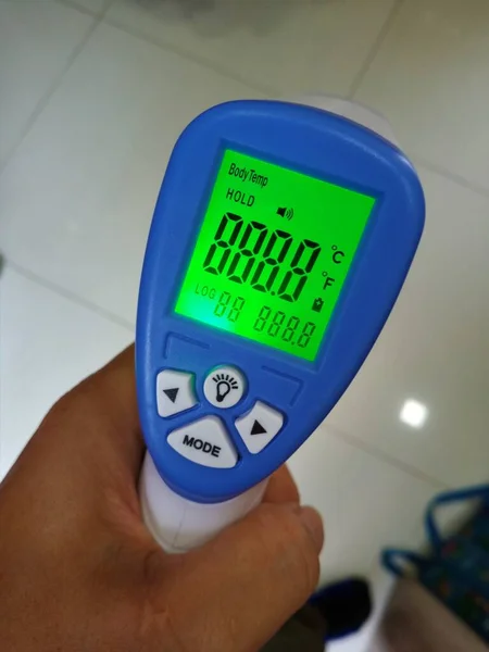 digital thermometer to check fever visitor at Information counter for scan and protect the Coronavirus COVID-19 Screening point for people before entering.