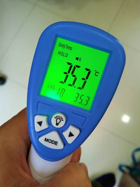 digital thermometer to check fever visitor at Information counter for scan and protect the Coronavirus COVID-19 Screening point for people before entering.