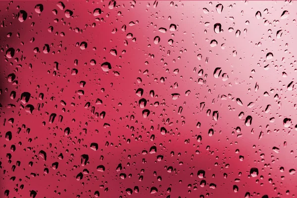 Regen rode achtergrond, regen water druppels op het raam of in de douche kraam, seizoen achtergrond, abstracte textuur behang — Stockfoto