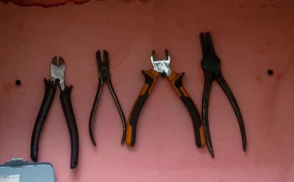 set of cutters and pliers on the stand or in the closet in the carpentry workshop. workplace order