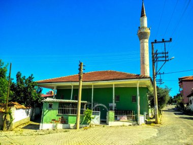 Green village mosque and minaret at the street in Denizli, Turkey clipart