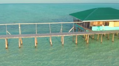 Aerial view of the pier with wooden arbors on a tropical Onok Island in Balabac, Philippines. travel vacation concept with white beach and endless turquoise water