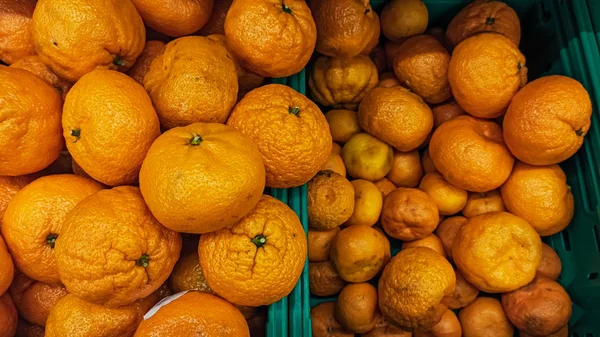 Healthy and organic oranges at the market. Lots of fresh orange fruits background.