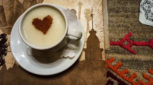 Turkish tradirional winter drink Sahlep (Salep) with heart shaped cinnamon powder in Turkey