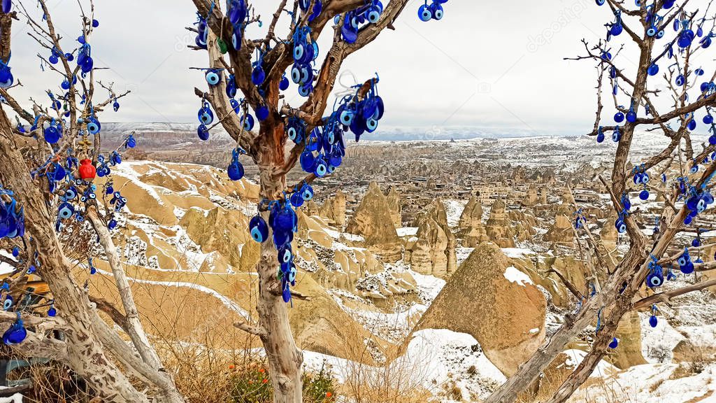 Fairy Chimneys at the valley covered with snow in winter in Goreme, Cappadocia, Turkey
