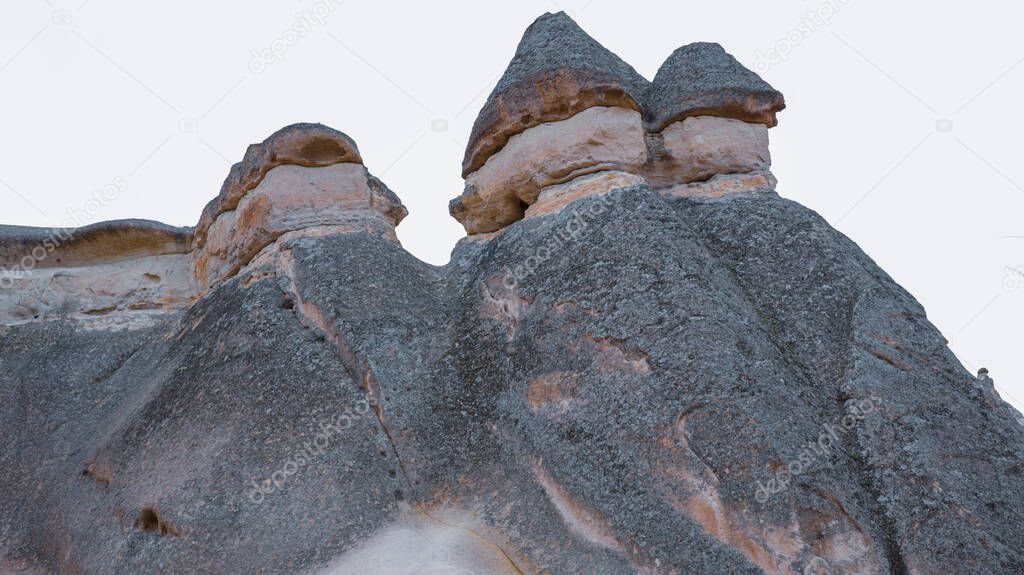 Fairy chimneys and cave houses surrounded by rock formations at Zelve Valley in Cappadocia, Turkey