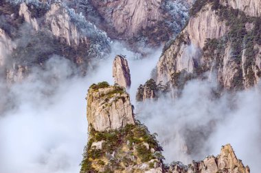 Sis Huangshan Milli Parkı'nda kayalar arasında.