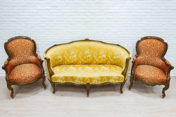 Old vintage luxury sofa and pair of armchairs. Stock Picture