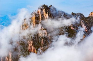 Bulutların üzerinde renkli doruklarına Huangshan Milli Parkı.