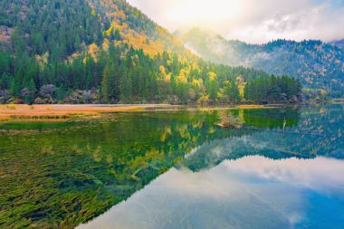 Autumn view of the lake with pure water at early morning time. clipart