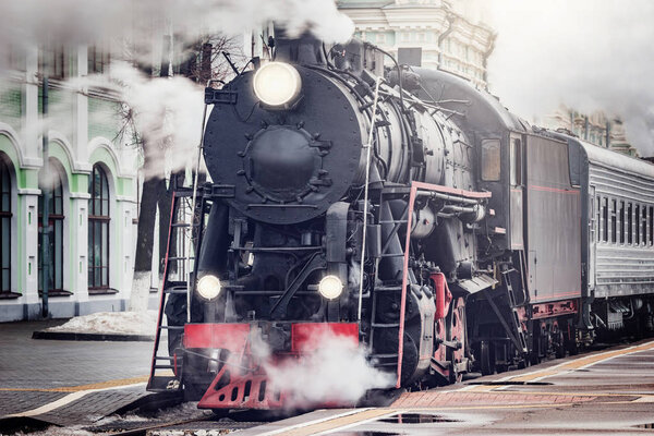 Steam train departs from the railway station. Moscow.