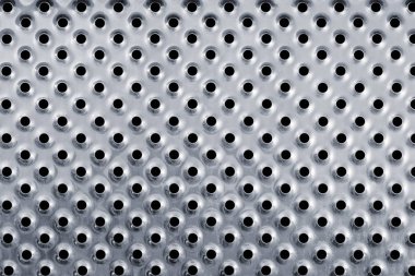 Delikli gümüş renkli metal arkaplan.