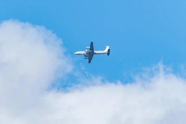 Flight of the big cargo airliner at sunny day time