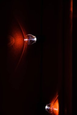 Karanlık bir odada tek tip bir ampul. Arkaplan için ampul ve kumaş.