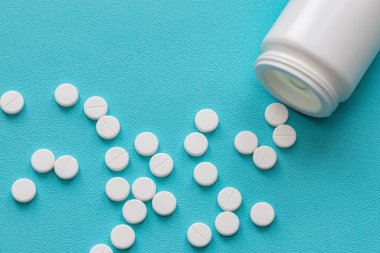 Vitaminler ve tabletler, yakın plan. Mavi arkaplan, metin eklenecek yer. Modern sağlık ve eczane.