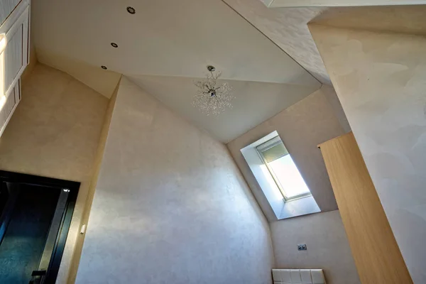 Light multistage plastered ceiling in a modern attic room with a Dormer window — Stock Image Light Multistage Plastered Ceiling Modern Attic Room Dormer Window Royalty Free Stock Photos
