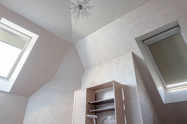 Light multistage plastered ceiling in a modern attic room with a Dormer window — Stock Image Light Multistage Plastered Ceiling Modern Attic Room Dormer Window Royalty Free Stock Images
