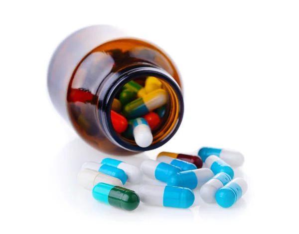 Pilulka a láhev na bílém pozadí — Stock fotografie
