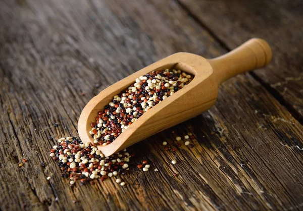 Quinoa semena v lopatka na dřevo — Stock fotografie