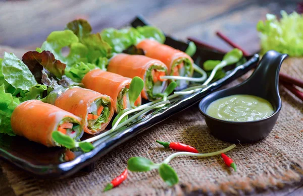 Salad roll  in black plate — Stock Photo, Image