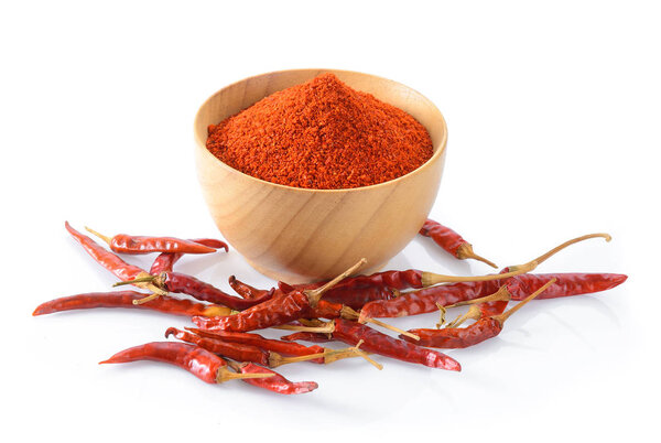 Cayenne pepper in wood bowl on white background