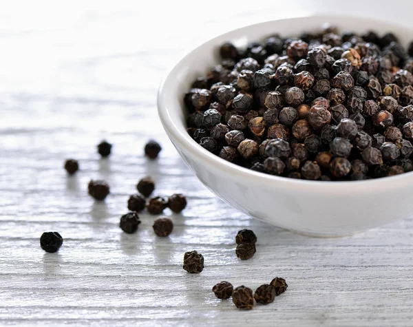 Black pepper in bowl on white background — Stock Photo, Image