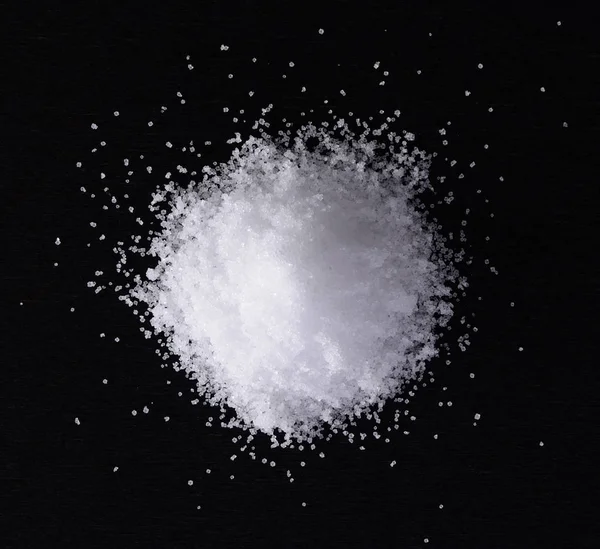 Salt on black wood — Stock Photo, Image