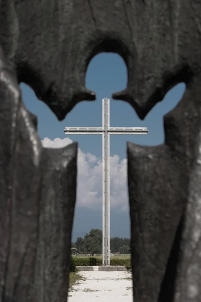 Cross visible through angel silhouette