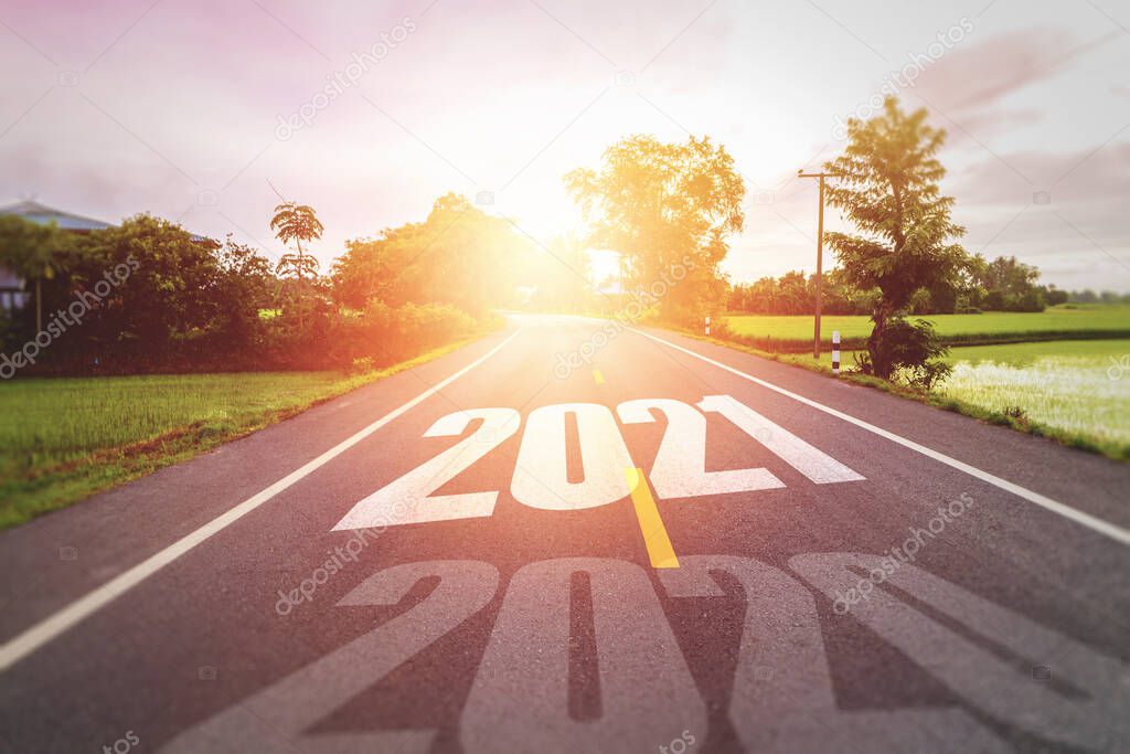 Concept new year With The word 2020 to 2021 Written on The asphalt  road in country road Decorate orange light for beauty Concept for new year of 2021